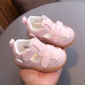 Vintage pink baby sandals with breathable cutout design and soft protective closed toe.