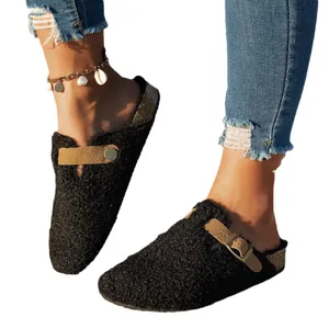 Women's black fuzzy closed-toe flat mules with adjustable buckle strap and cozy soft lining