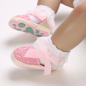 Detailed view of pink lace baby sandals with cute ribbon bow for newborn infant girls