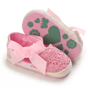 Detailed view of pink baby girl lace sandals with bow and patterned fabric sole