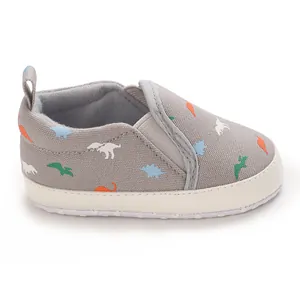 Side view of grey baby soft sole walking shoe with colorful dinosaur print