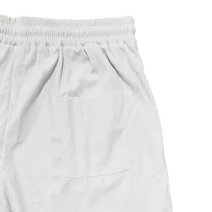 Close-up of white corduroy shorts showing elastic waistband and back pocket detail