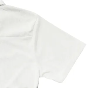 Close-up detail of white textured polo shirt showing fabric weave and shoulder seam.