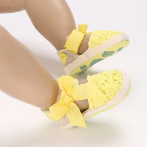 Close-up view of yellow baby girl lace sandals featuring a bow and breathable cloth sole