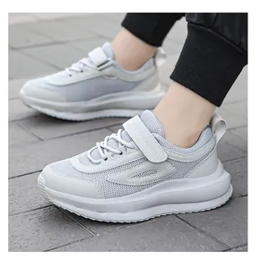 Vista dettagliata di scarpe da corsa traspiranti per bambini con velcro in grigio.