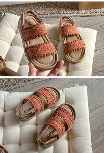 Close-up view of girls' retro orange knit sandals with soft soles for summer beach wear