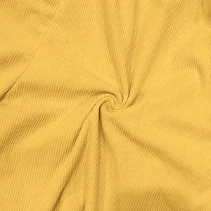 Close-up detail of premium soft yellow corduroy ribbed fabric texture for men's shorts