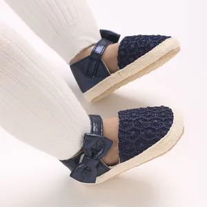 Close-up detail of navy blue baby girl princess shoes featuring a cute bowknot and non-slip sole