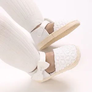 Detailed macro view of white lace baby princess shoes featuring a cute bow and non-slip sole