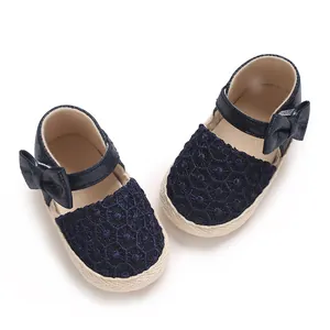 Detailed view of navy blue baby princess shoes with lace texture and cute bow