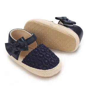 Detail of cute navy blue baby girl princess shoes with non-slip rubber sole and bow accent
