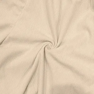 Close-up macro shot of beige corduroy fabric texture for men's casual shorts