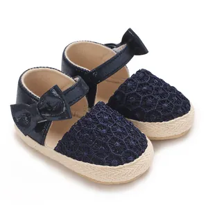 Detail view of navy blue baby princess shoes with lace embroidery and bow