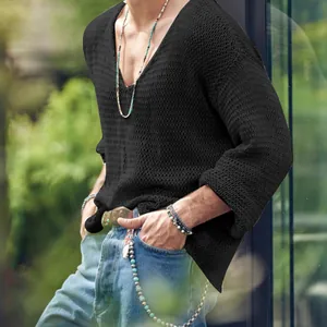 Close-up detail of a men's retro black hollow-out knit sweater with deep V-neck.