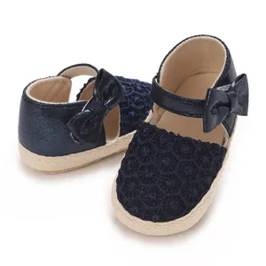 Detailed macro view of navy blue lace baby girl princess shoes with decorative silk bow
