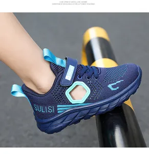 Close-up of navy blue mesh boy's sports shoe with breathable side cutout.