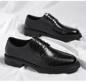 Close-up of black men's business leather shoes with breathable laser-cut hollow design