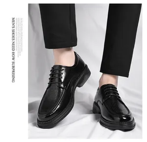 Detail view showing black perforated leather dress shoes for summer breathability