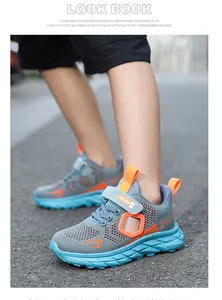 Detailed view of breathable grey mesh boys sneakers with orange and blue accents