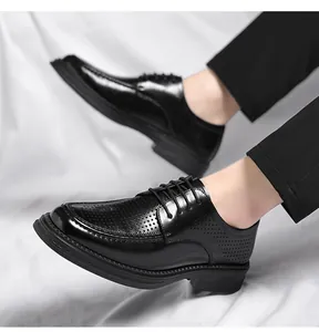 Detail of black men's breathable hollowed leather oxfords for formal business wear.