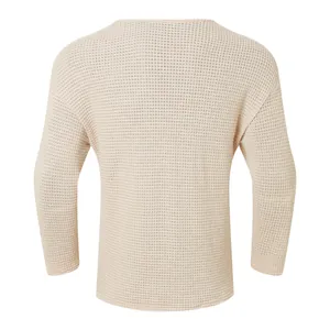 Back view detail of a beige waffle knit sweater showing textured honeycomb pattern