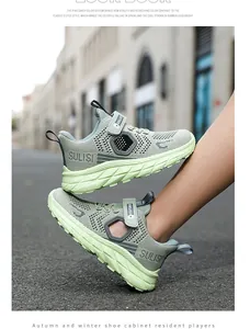 Close-up of lightweight green mesh running shoes for boys featuring adjustable velcro straps