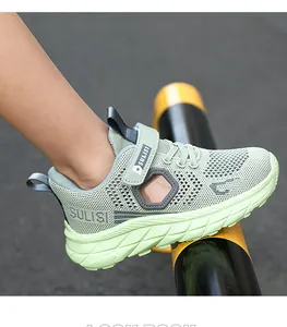 Detail shot of breathable mesh upper on boys' mint green lightweight running shoes.