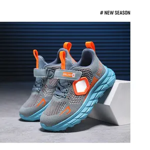 Detailed view of lightweight mesh running shoes for boys in grey and orange