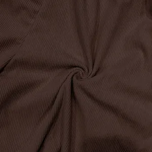 Macro view of dark brown ribbed corduroy fabric showing soft texture detail