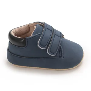 Detailed side view of navy blue baby boy sneakers with double hook-and-loop velcro straps