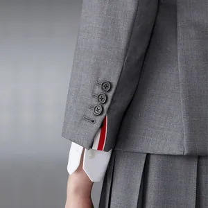 Premium high-end gray suit sleeve featuring shell buttons and iconic striped cuff detail.