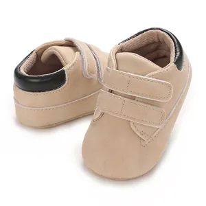 Baskets pour bébés à semelle souple avec bandes velcro beige et noir pour petits.