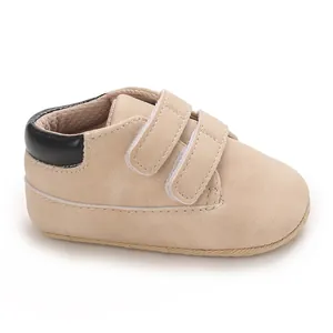 Close-up view of khaki baby boy pre-walker sneakers with double hook-and-loop straps