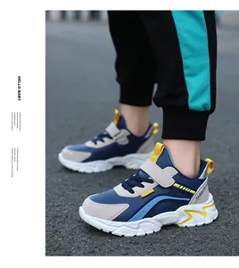 Detailed side view of kids' blue and gray sneakers with yellow accents and strap.