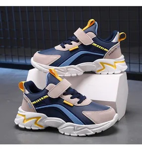 Side view of durable kids fashion sneakers featuring velcro strap and thick white sole