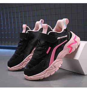 Side view of stylish black and pink children's running sneakers on a display block.