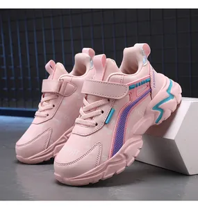Side detail of pink girls running shoes featuring velcro strap and colorful chunky sole