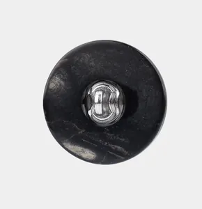 Close-up detail of a natural black lip shell button back with a durable silver metal shank