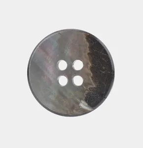 Macro view of a natural black mother of pearl shell button with iridescent texture.