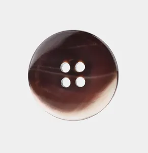 Macro detail of a high-quality natural brown shell button with four holes for suits
