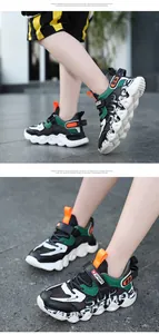 Macro view of boys hollow breathable sports shoes with green and black accents.
