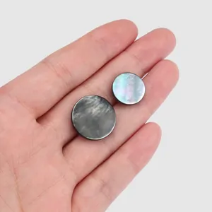 Pair of round iridescent natural black lip shell buttons for elegant silk dress decor
