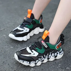 Breathable boys hollow mesh sneakers with non-slip thick soles in outdoor on-feet view