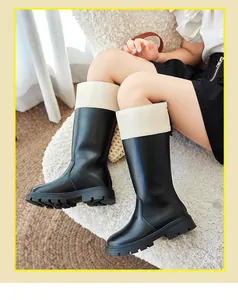 Detail view of children's British style black and cream two-tone knight boots