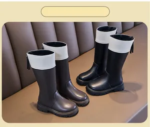 Detailed view of black and brown girls' knight boots with white collar and back zippers