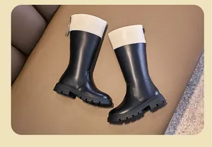 Detailed view of children's British-style tall boots with a stylish back zipper design.