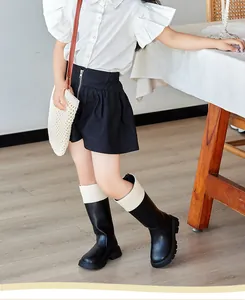 Detail view of girls black and white British style Martin boots with back zipper closure
