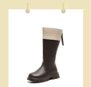 Detailed side view of two-tone brown and cream children's riding boots with back zipper