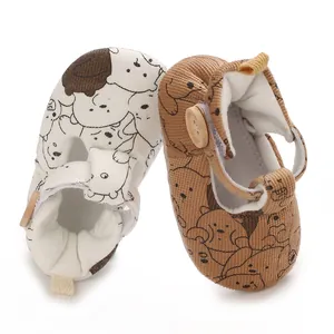 Detailed close-up of soft-soled baby shoes highlighting the fabric texture and cute dog prints