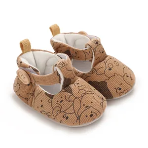 Detailed view of soft sole corduroy baby pre-walker shoes with cute cartoon bear patterns